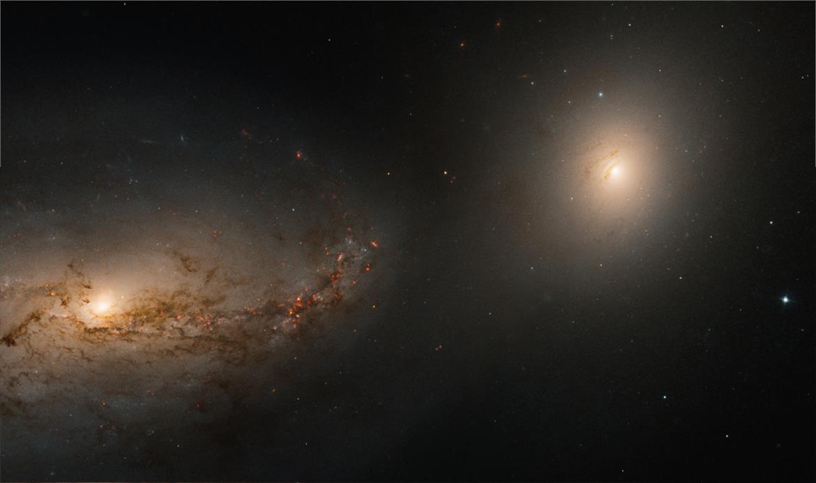 Stunning Hubble Image Captures Two Galaxies Dancing With A Cannibalized Cosmic Cadaver