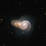 Hubble Telescope Snaps Enchanting Shot Of Two Galaxies Intertwined In Cosmic Embrace